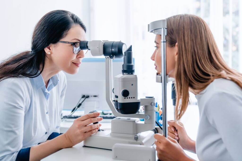 Ophthalmologist doctor examining woman eye