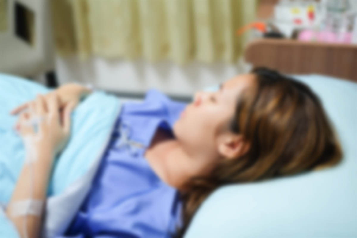 sick woman in hospital bed